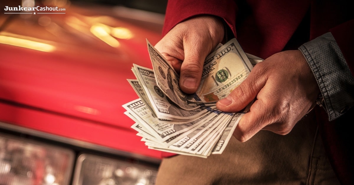 Man happily selling car for cash, avoiding expensive repairs