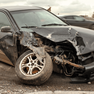 Abandoned junk car on the roadside with visible damage